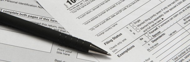Desk with financial and tax papers and pen